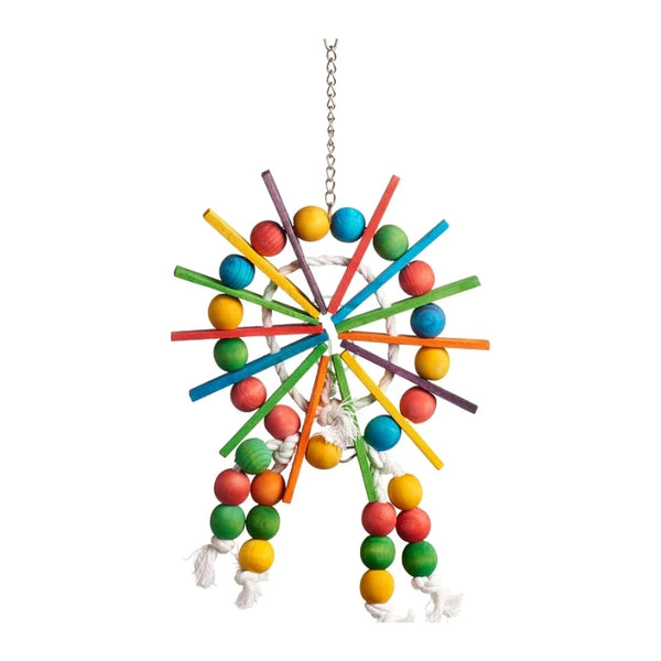 A colorful bird toy hanging from a silver chain, featuring multiple radiating wooden sticks in blue, green, red, yellow, orange, and purple, surrounded by multicolored wooden beads and white rope tassels.